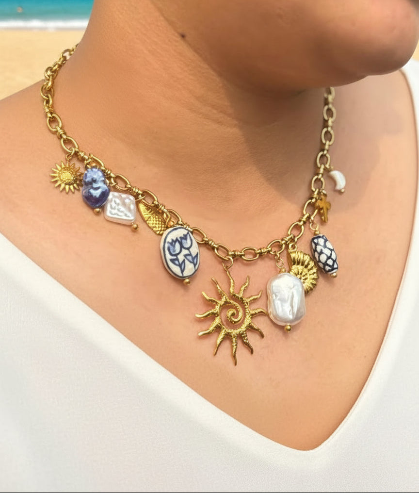 Necklace with various charms worn by a person